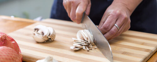 Slicing mushrooms on a cutting board