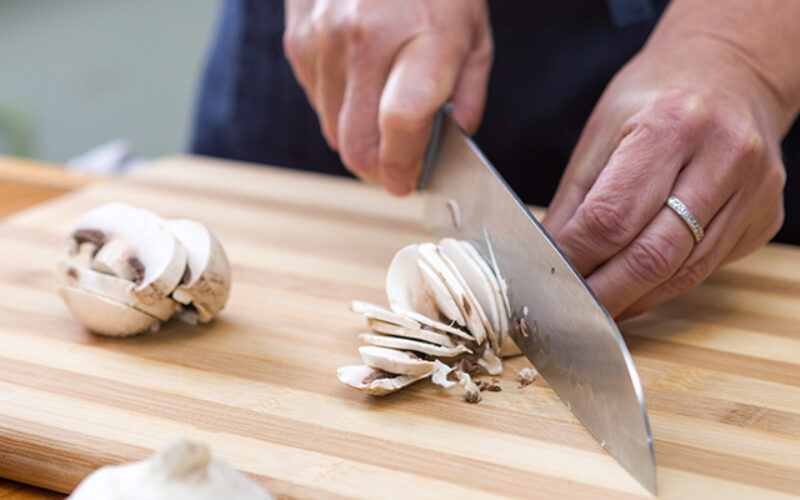 Slicing mushrooms on a cutting board